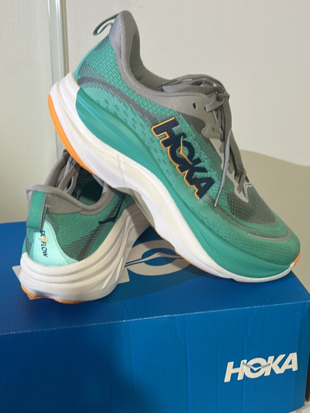 Hoka Teal and Gray Lightweight Running Sneakers with Orange Accent sky flow